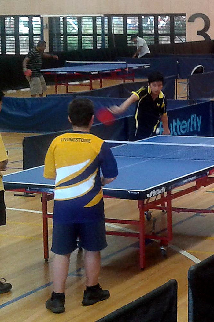 A children's table tennis match during an ASC table tennis camp in an indoor gymnasium