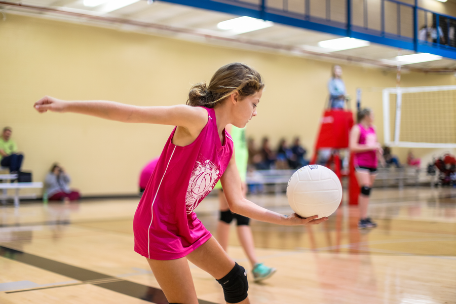 Practising serving at a volleyball sports camp