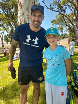 Legendary cricketer Mitchell Johnson with a young female cricketer at an ASC cricket camp in Perth