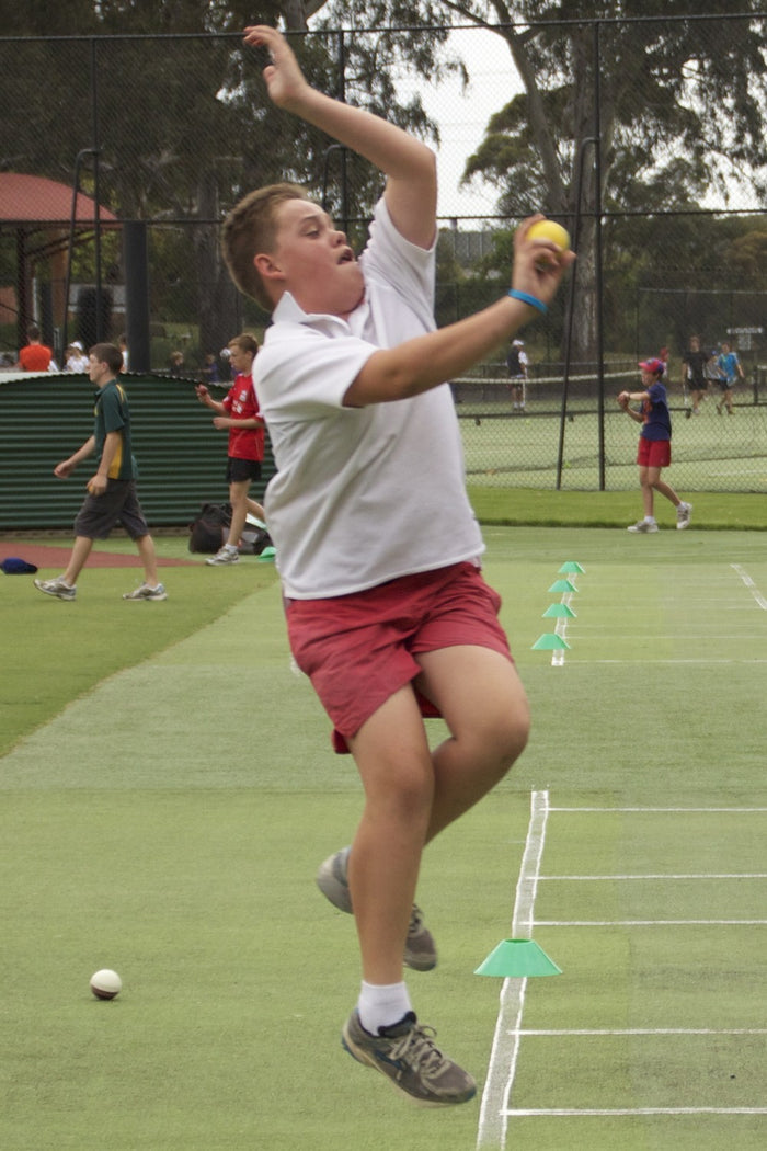 Teenage boy improving his bowling skills at an ASC cricket camp