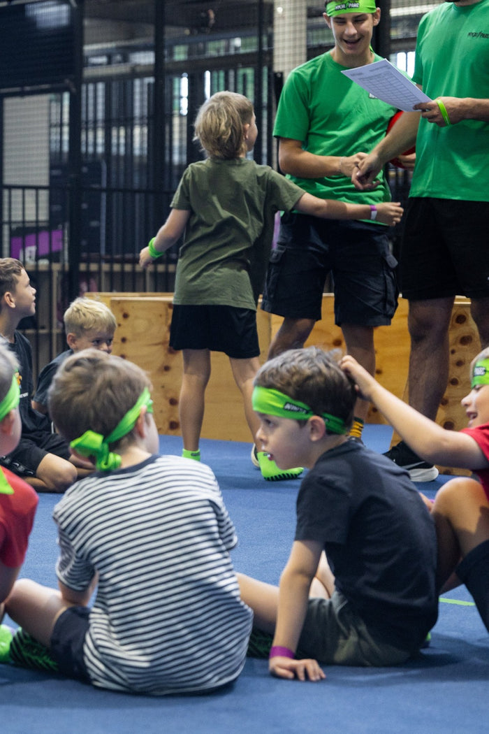 A group of children with their instructors at ASC's Ninja Parc parkour skills training program