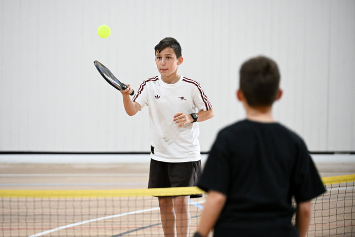 Two boys rallying at an ASC pickleball camp
