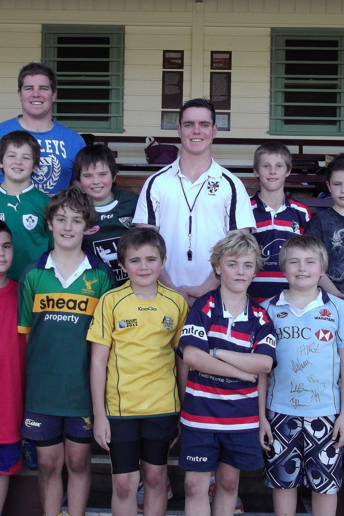 Group of boys with their coach at an ASC rugby league camp