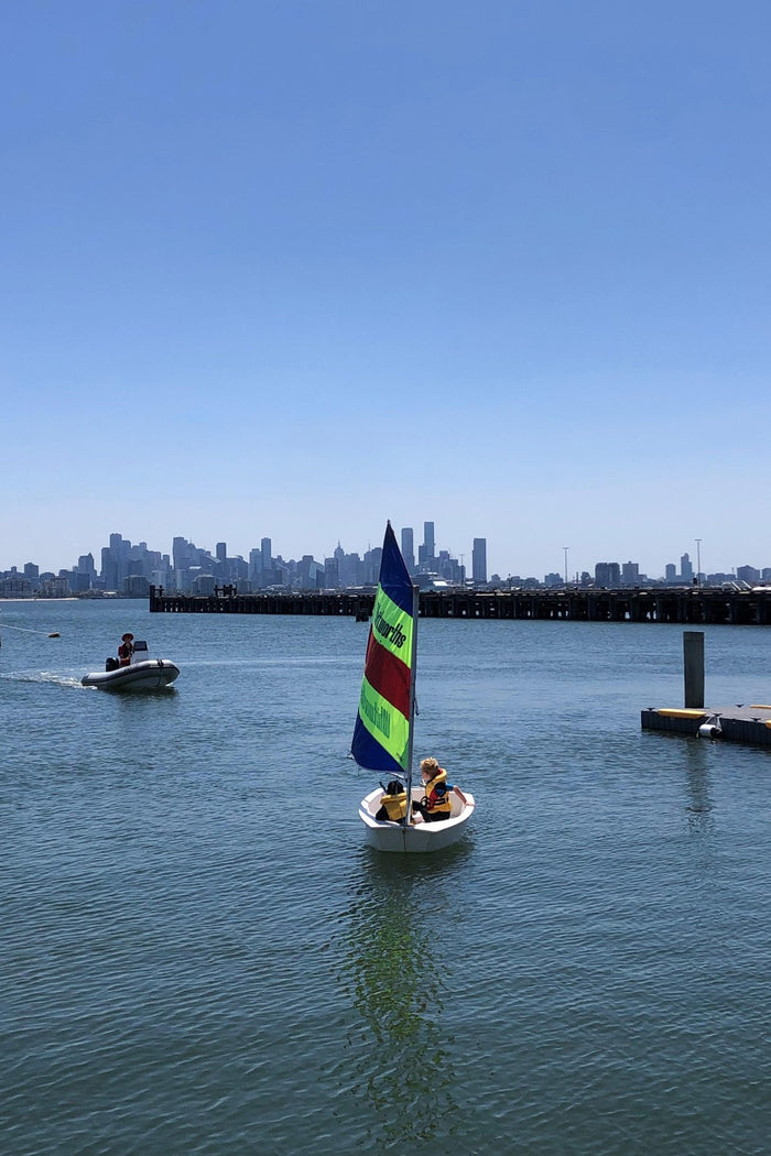 Two young boys practising  their sailing skills under the watchful eye of the instructor at an ASC sailing program