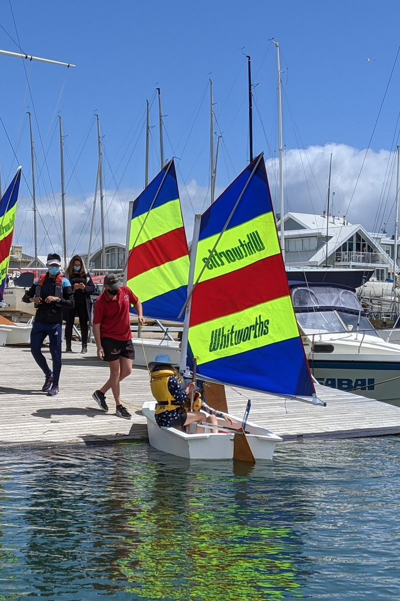 Launching dinghy's at an ASC sailing camp, with instructor and parents watching on