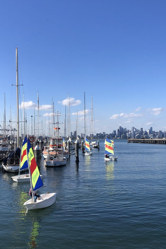On the water practising tacking and jibing at an ASC sailing program