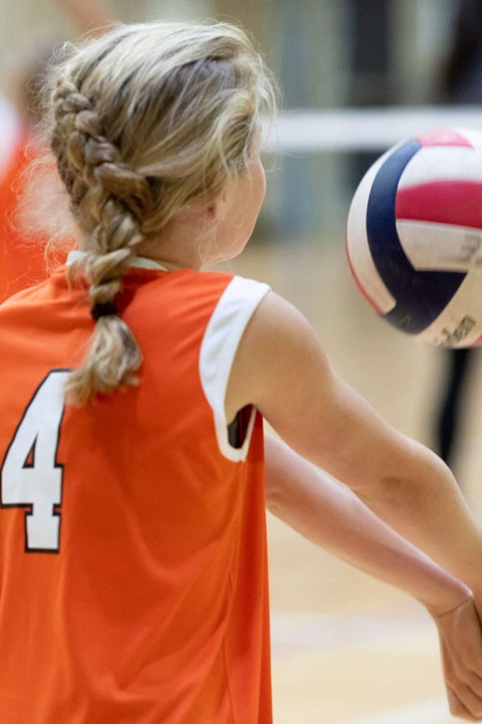 Girl taking a set shot at an ASC volleyball camp.